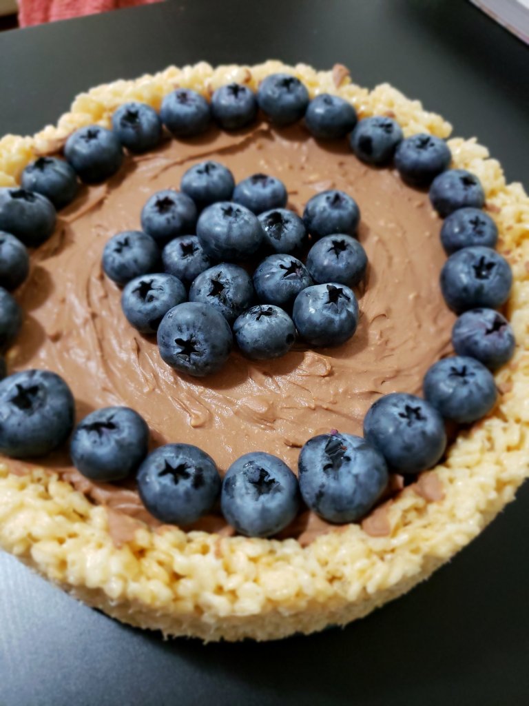 Another photo of the No Bake Chocolate Cheesecake with Rice Krispy crust, topped with Fresh Blueberries viewed at an angle.